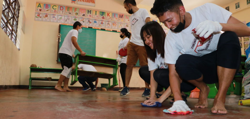 Employee-volunteers of ePLDT clean classrooms during Ready for School activities in EM Signal Villlage Elementary School.